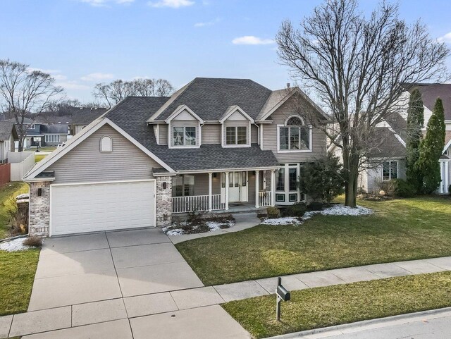 18036 Crystal Ln, Lansing, IL 60438 - view of front of house featuring covered porch, an attached garage, concrete driveway, a front lawn, and a shingled roof