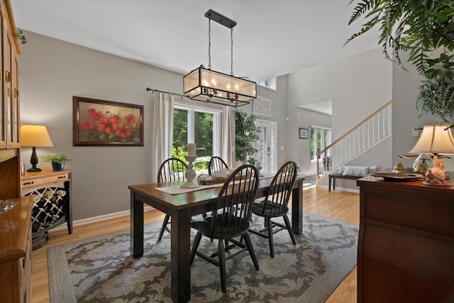 7488 Bittersweet Dr, Gurnee, IL 60031 - dining area with a chandelier, stairs, and light wood-type flooring