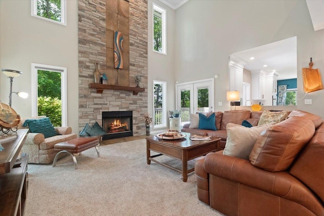 7488 Bittersweet Dr, Gurnee, IL 60031 - living room with a towering ceiling, healthy amount of natural light, light carpet, a fireplace, and ornamental molding