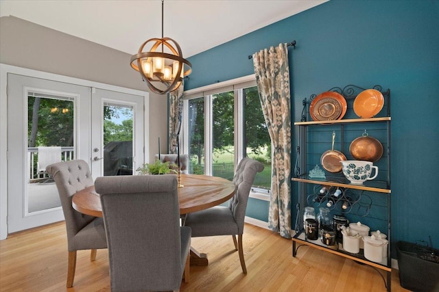 7488 Bittersweet Dr, Gurnee, IL 60031 - dining space featuring french doors, healthy amount of natural light, a chandelier, and wood finished floors
