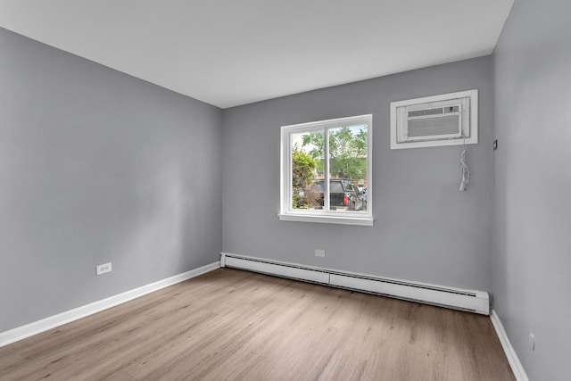 6 E Dundee Quarter Dr Unit 101, Palatine, IL 60074 - spare room featuring a baseboard heating unit, wood finished floors, and an AC wall unit