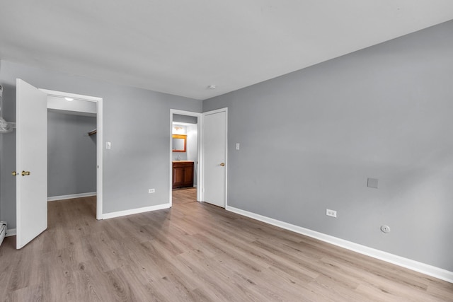 6 E Dundee Quarter Dr Unit 101, Palatine, IL 60074 - unfurnished bedroom with wood finished floors, a walk in closet, a closet, and connected bathroom