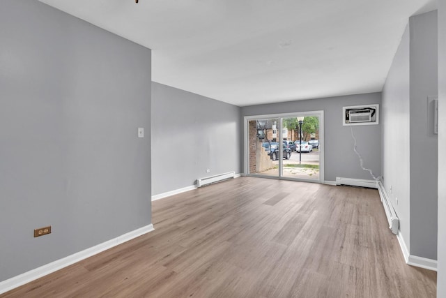 6 E Dundee Quarter Dr Unit 101, Palatine, IL 60074 - empty room with a baseboard radiator, a wall mounted AC, light wood-style floors, and baseboard heating