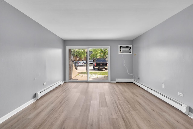 6 E Dundee Quarter Dr Unit 101, Palatine, IL 60074 - empty room with baseboard heating, wood finished floors, and a wall mounted air conditioner