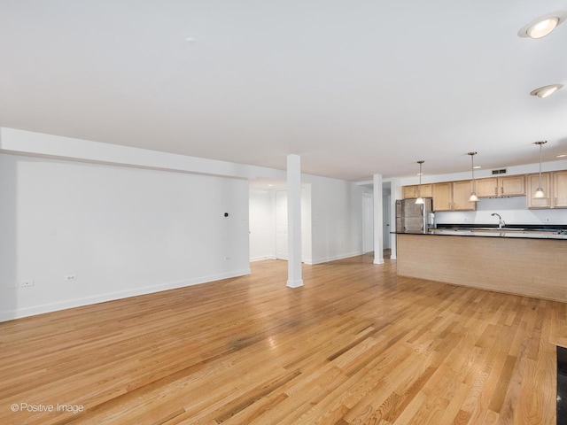 4411 N Beacon St Unit G, Chicago, IL 60640 - unfurnished living room with a sink and light wood-type flooring