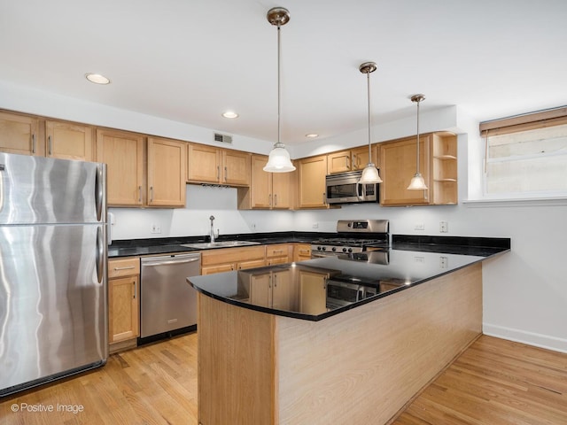 4411 N Beacon St Unit G, Chicago, IL 60640 - kitchen with stainless steel appliances, light wood-style flooring, dark countertops, a peninsula, and open shelves