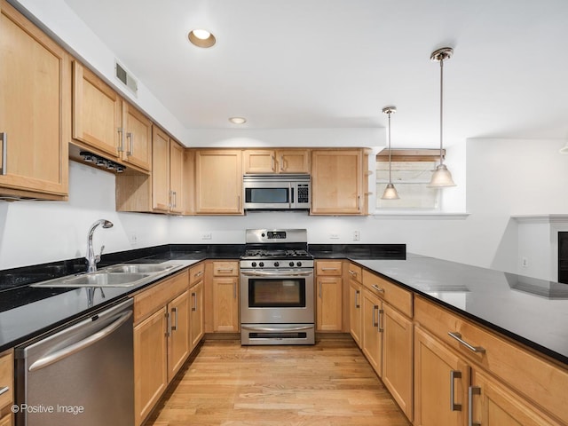4411 N Beacon St Unit G, Chicago, IL 60640 - kitchen with stainless steel appliances, light wood-style flooring, dark countertops, pendant lighting, and recessed lighting