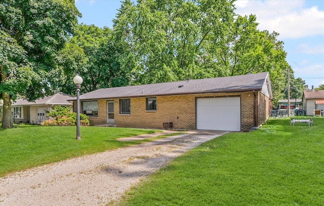 205 Buena Vista Dr, Champaign, IL 61820 - ranch-style home with driveway, an attached garage, brick siding, a front lawn, and a shingled roof