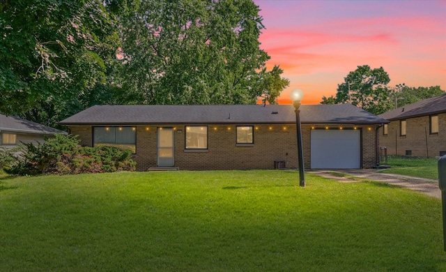 205 Buena Vista Dr, Champaign, IL 61820 - ranch-style home with a garage, brick siding, a lawn, and concrete driveway