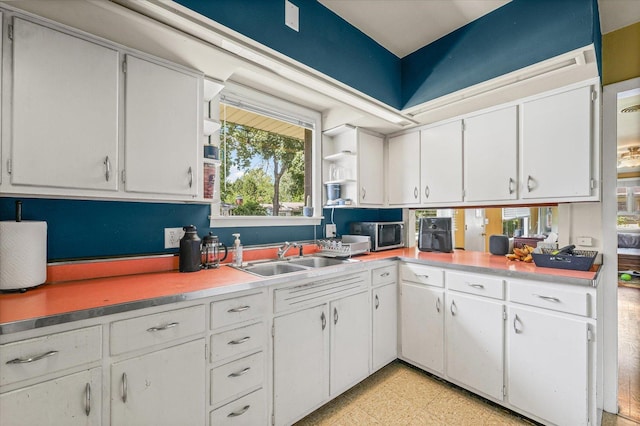 205 Buena Vista Dr, Champaign, IL 61820 - kitchen with white cabinetry, open shelves, and light countertops