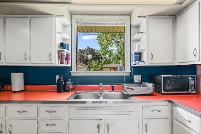 205 Buena Vista Dr, Champaign, IL 61820 - kitchen with stainless steel microwave, open shelves, white cabinets, and light countertops