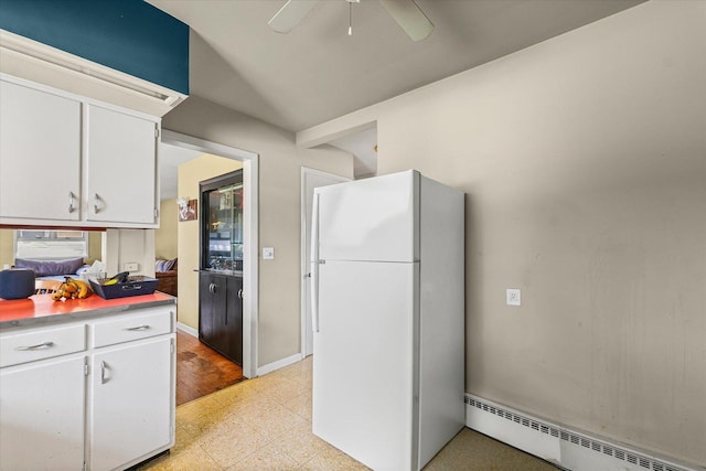 205 Buena Vista Dr, Champaign, IL 61820 - kitchen with baseboard heating, freestanding refrigerator, white cabinets, light countertops, and ceiling fan
