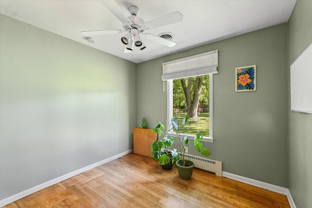 205 Buena Vista Dr, Champaign, IL 61820 - unfurnished room with light wood-type flooring, a ceiling fan, and a baseboard radiator