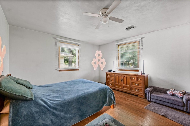 205 Buena Vista Dr, Champaign, IL 61820 - bedroom featuring wood finished floors, ceiling fan, and a textured ceiling