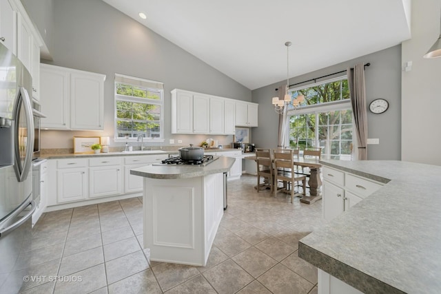 424 Bluegrass Ln, Geneva, IL 60134 - kitchen with stainless steel appliances, a chandelier, high vaulted ceiling, a center island, and white cabinets