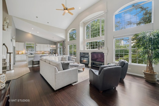424 Bluegrass Ln, Geneva, IL 60134 - living room with high vaulted ceiling, a ceiling fan, dark wood-style floors, a glass covered fireplace, and recessed lighting