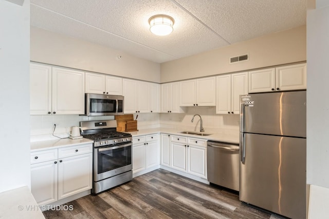 59 S Hale St Unit 203, Palatine, IL 60067 - kitchen with appliances with stainless steel finishes, dark wood-type flooring, white cabinetry, a textured ceiling, and light countertops