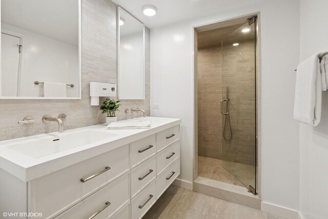 161 E Chicago Ave Unit 27C, Chicago, IL 60611 - full bath with double vanity, a stall shower, wood finished floors, and decorative backsplash