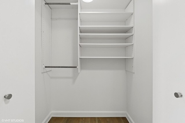 161 E Chicago Ave Unit 27C, Chicago, IL 60611 - walk in closet featuring dark wood-type flooring