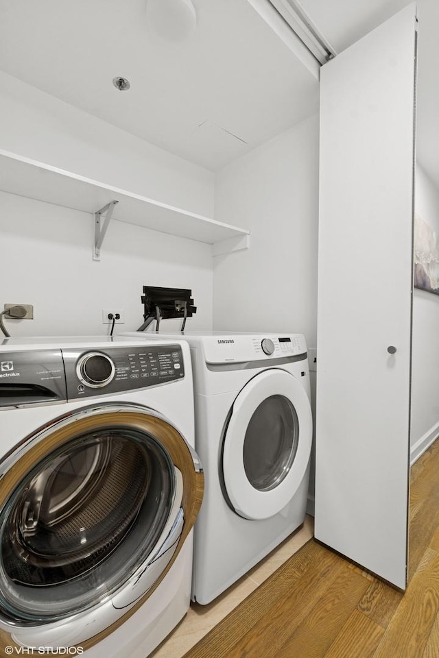 161 E Chicago Ave Unit 27C, Chicago, IL 60611 - washroom with separate washer and dryer and light wood finished floors