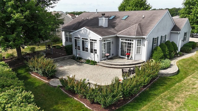 424 Riverbend Dr, Genoa, IL 60135 - back of house featuring a chimney, a lawn, and a shingled roof