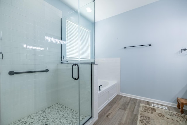 424 Riverbend Dr, Genoa, IL 60135 - bathroom featuring wood finished floors, a bath, and a shower stall