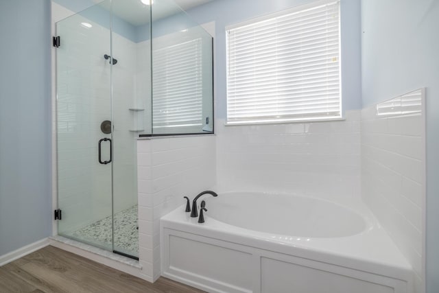 424 Riverbend Dr, Genoa, IL 60135 - bathroom featuring wood finished floors, a bath, and a stall shower