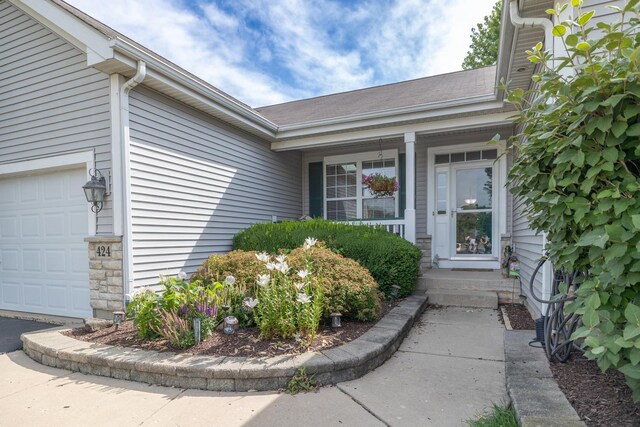 424 Riverbend Dr, Genoa, IL 60135 - doorway to property featuring an attached garage