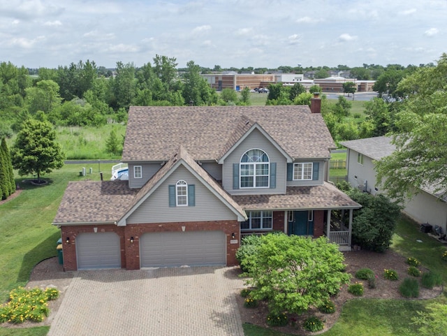 16107 Carlow Cir, Manhattan, IL 60442 - traditional-style home with brick siding, a front lawn, decorative driveway, a shingled roof, and an attached garage