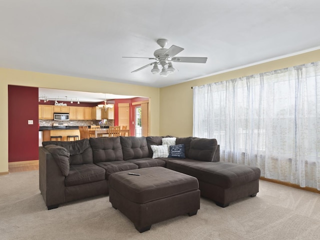 16107 Carlow Cir, Manhattan, IL 60442 - living area with light carpet, a ceiling fan, and a chandelier