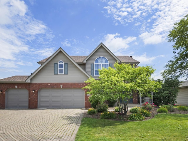 16107 Carlow Cir, Manhattan, IL 60442 - traditional-style home with brick siding, decorative driveway, a front lawn, a garage, and roof with shingles
