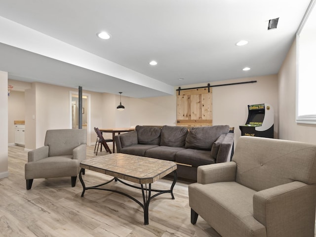 16107 Carlow Cir, Manhattan, IL 60442 - living room featuring a barn door, light wood-type flooring, and recessed lighting