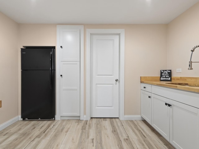 16107 Carlow Cir, Manhattan, IL 60442 - kitchen featuring freestanding refrigerator, wooden counters, light wood-style floors, and white cabinetry