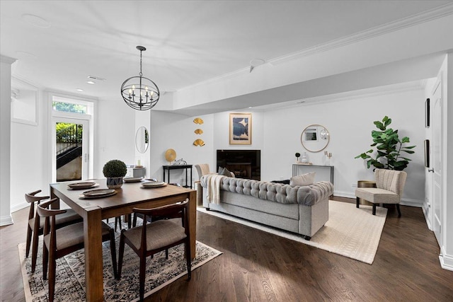 506 W Oakdale Ave Unit 1, Chicago, IL 60657 - dining space featuring a chandelier, a fireplace, crown molding, and dark wood-style floors