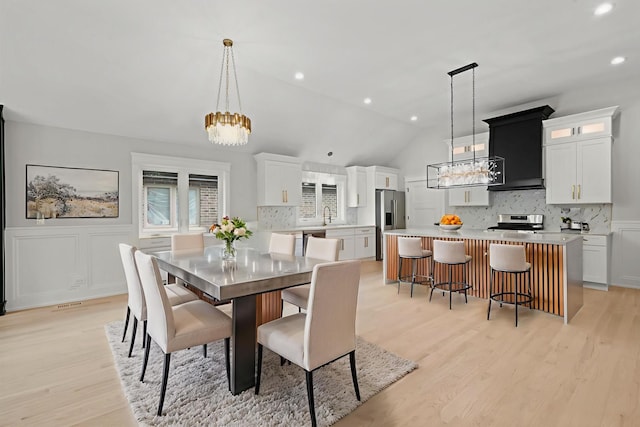 8545 Mansfield Ave, Burbank, IL 60459 - dining room with a chandelier, light wood-type flooring, vaulted ceiling, wainscoting, and recessed lighting