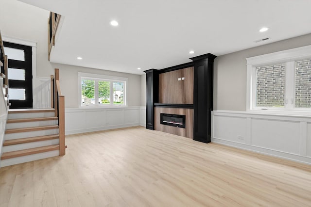 8545 Mansfield Ave, Burbank, IL 60459 - unfurnished living room featuring a decorative wall, wood finished floors, a fireplace, a wainscoted wall, and recessed lighting