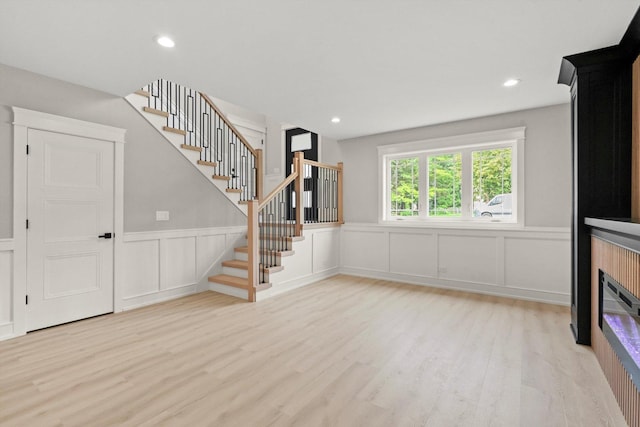 8545 Mansfield Ave, Burbank, IL 60459 - unfurnished living room with a decorative wall, stairs, wood finished floors, a wainscoted wall, and recessed lighting