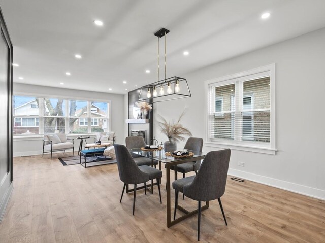 2640 N 76th Ct, Elmwood Park, IL 60707 - dining area with wood finished floors, recessed lighting, and a glass covered fireplace