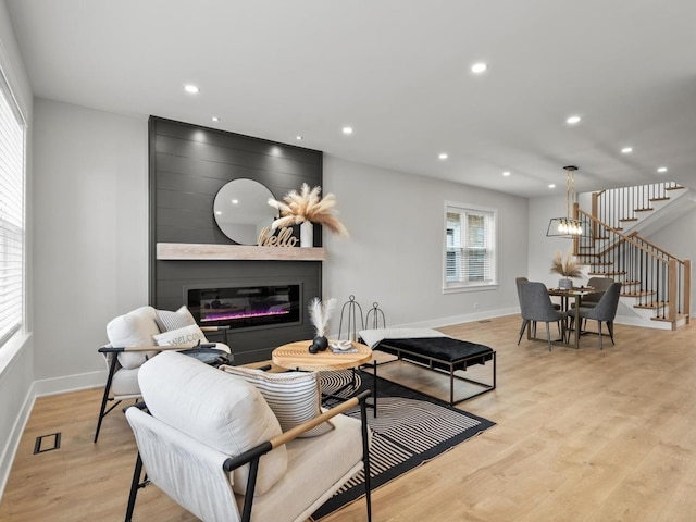 2640 N 76th Ct, Elmwood Park, IL 60707 - living area with stairs, light wood-style floors, a fireplace, and recessed lighting