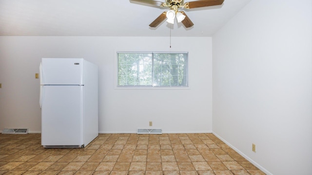 17 Kingswood Dr, Normal, IL 61761 - kitchen with freestanding refrigerator, ceiling fan, and light stone finish floors