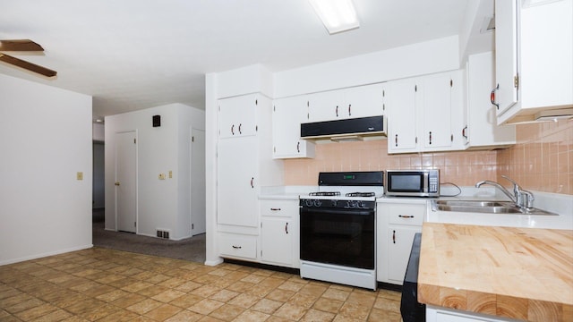 17 Kingswood Dr, Normal, IL 61761 - kitchen with white gas range oven, stainless steel microwave, under cabinet range hood, light countertops, and tasteful backsplash
