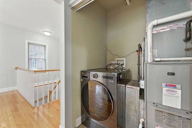 2611 W Rosemont Ave Unit A, Chicago, IL 60659 - laundry room featuring washer / dryer, heating unit, and wood finished floors