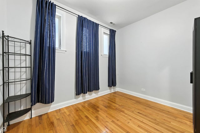 2611 W Rosemont Ave Unit A, Chicago, IL 60659 - unfurnished room with light wood-style floors and baseboards