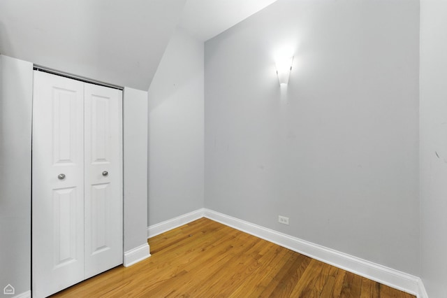 2611 W Rosemont Ave Unit A, Chicago, IL 60659 - unfurnished bedroom featuring light wood-style floors, lofted ceiling, and a closet
