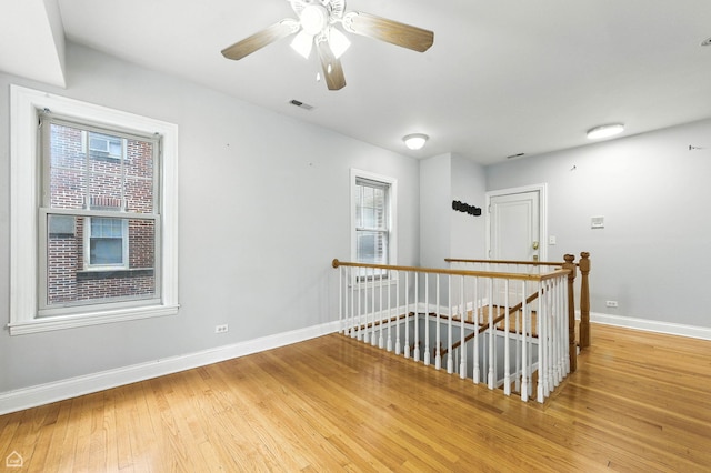 2611 W Rosemont Ave Unit A, Chicago, IL 60659 - spare room featuring wood finished floors and a ceiling fan