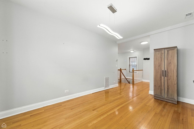 2611 W Rosemont Ave Unit A, Chicago, IL 60659 - empty room with light wood-type flooring and baseboards