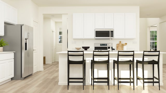 572 Waterford Rd, Elgin, IL 60124 - kitchen featuring white appliances, light wood finished floors, white cabinets, and a breakfast bar