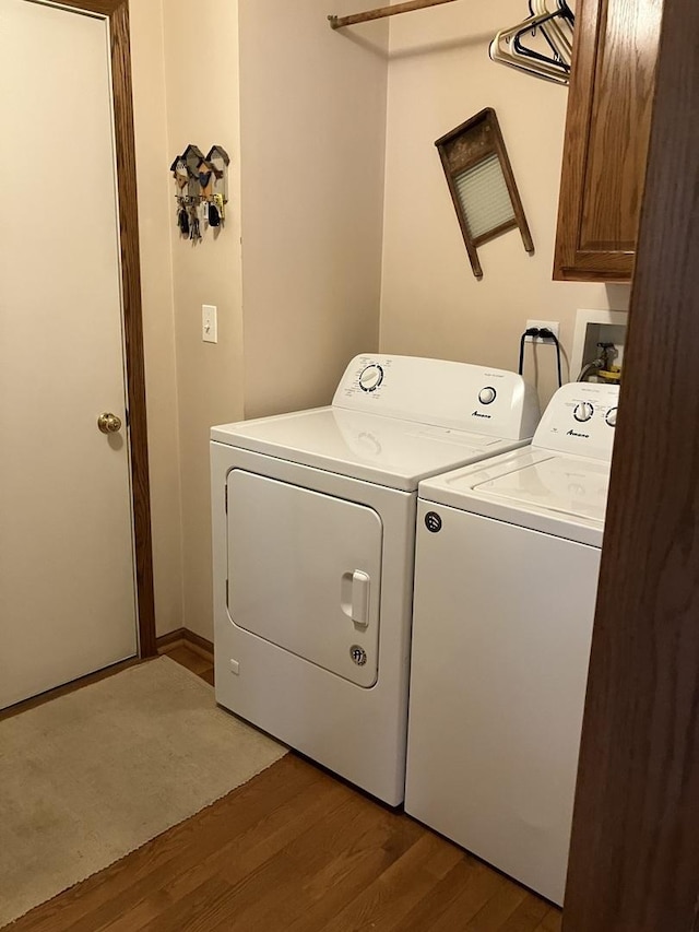 1669 Saint Ann Dr, Hanover Park, IL 60133 - washroom featuring light wood-type flooring, cabinet space, and washing machine and clothes dryer