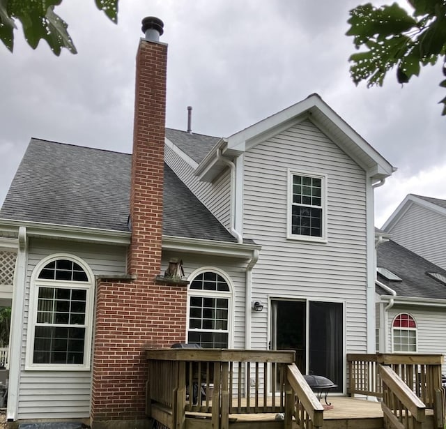 1669 Saint Ann Dr, Hanover Park, IL 60133 - back of house with a wooden deck, roof with shingles, and a chimney