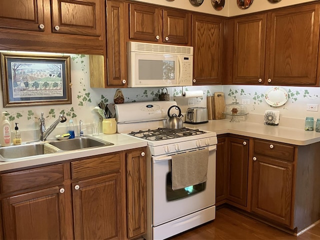 1669 Saint Ann Dr, Hanover Park, IL 60133 - kitchen with white appliances, light countertops, brown cabinetry, and dark wood-style floors